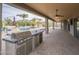 Outdoor kitchen and grill with a covered patio and views of the backyard and pool at 38820 N 10Th St, Phoenix, AZ 85086
