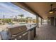 Outdoor kitchen and grill with a covered patio and views of the pool and backyard at 38820 N 10Th St, Phoenix, AZ 85086