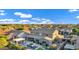 Wide angle neighborhood shot of mature landscaping, a bright blue sky, and many beautiful single-Gathering homes at 3930 E Enrose St, Mesa, AZ 85205