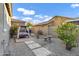 A backyard featuring stone landscaping, a covered swing, and a block wall fence at 3930 E Enrose St, Mesa, AZ 85205