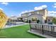 Beautiful backyard with artificial grass, a patio and a two story home in the background at 3930 E Enrose St, Mesa, AZ 85205