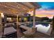 Serene backyard with a pool, spa, and pergola illuminated by string lights at 3930 E Enrose St, Mesa, AZ 85205