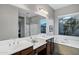 The bathroom features double sinks, a soaking tub, and a walk-in shower, offering a luxurious and functional space at 3930 E Enrose St, Mesa, AZ 85205