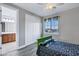 Bright bedroom with a window, ceiling fan, and an ensuite bathroom at 3930 E Enrose St, Mesa, AZ 85205