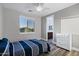 Bedroom showcasing a bed, dresser, and large window providing ample natural light at 3930 E Enrose St, Mesa, AZ 85205