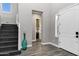 Bright entryway with gray walls and dark wood stairs, complemented by a decorative teal vase at 3930 E Enrose St, Mesa, AZ 85205