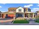 Charming two-story home featuring a brick driveway, vibrant lawn, and a welcoming front porch at 3930 E Enrose St, Mesa, AZ 85205