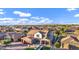 Beautiful two-story home featuring lush landscaping, a red garage door, and a charming front porch at 3930 E Enrose St, Mesa, AZ 85205