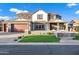 Impressive two-story home with a three-car garage, manicured lawn, and inviting front porch at 3930 E Enrose St, Mesa, AZ 85205