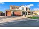 Two-story home showcasing three-car garage, paver driveway, manicured lawn, and a charming front porch at 3930 E Enrose St, Mesa, AZ 85205