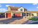 Expansive home featuring a brick driveway, three-car garage and a lush lawn at 3930 E Enrose St, Mesa, AZ 85205