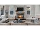 Cozy living room area with a stone fireplace, large TV, and comfortable seating at 3930 E Enrose St, Mesa, AZ 85205