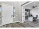 Bright foyer featuring modern gray walls, stylish hardwood floors, and access to a home office at 3930 E Enrose St, Mesa, AZ 85205