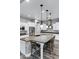 Bright kitchen featuring a large island with bar seating, stainless steel appliances, and custom pendant lighting at 3930 E Enrose St, Mesa, AZ 85205