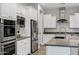 The kitchen features white cabinets, stainless steel appliances, granite countertops, and mosaic backsplash, creating a modern and clean aesthetic at 3930 E Enrose St, Mesa, AZ 85205