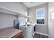 Bright laundry room with a front-loading washer and dryer and shelving at 3930 E Enrose St, Mesa, AZ 85205