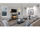 Bright and airy living room with gray sofa, stone fireplace and wood-look floors at 3930 E Enrose St, Mesa, AZ 85205