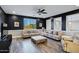 Comfortable living room featuring neutral couches, an ottoman, and dark accent walls at 3930 E Enrose St, Mesa, AZ 85205