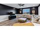 A living room with a black accent wall and lots of seating at 3930 E Enrose St, Mesa, AZ 85205