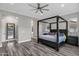 The main bedroom has a four-poster bed, neutral walls, and large windows, creating a serene and inviting atmosphere at 3930 E Enrose St, Mesa, AZ 85205