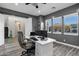 Bright office space with gray walls, a white desk, and three windows for optimal natural light at 3930 E Enrose St, Mesa, AZ 85205
