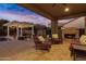 Inviting outdoor space with comfortable seating, a cozy fireplace, and stylish patio under a covered area at 3930 E Enrose St, Mesa, AZ 85205