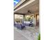 Cozy covered patio with comfortable seating and a fireplace, perfect for outdoor relaxation at 3930 E Enrose St, Mesa, AZ 85205