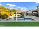 A swimming pool and hot tub area with a green artificial grass at 3930 E Enrose St, Mesa, AZ 85205