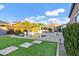 A swimming pool with a hot tub and a white pergola in a backyard with artificial grass at 3930 E Enrose St, Mesa, AZ 85205