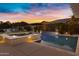 Tranquil pool and spa in a well-landscaped backyard at sunset at 3930 E Enrose St, Mesa, AZ 85205