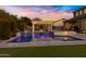 Elegant pool with a spa and pergola, beautifully illuminated at twilight at 3930 E Enrose St, Mesa, AZ 85205