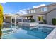 A beautiful pool with a hot tub and seating areas, with the two story home as a backdrop at 3930 E Enrose St, Mesa, AZ 85205