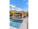 Backyard oasis featuring a pool, spa, and pergola with a built-in table, perfect for outdoor gatherings at 3930 E Enrose St, Mesa, AZ 85205