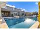 Beautiful pool with a hot tub, set against a backdrop of a two story home and blue skies at 3930 E Enrose St, Mesa, AZ 85205