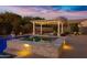 Relaxing backyard featuring a pool and spa with pergola and string lights perfect for evening entertainment at 3930 E Enrose St, Mesa, AZ 85205
