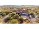 An aerial view showcases this home's desert landscape and a terracotta tile roof, featuring a spacious driveway and attached garage at 44434 N 20Th St, New River, AZ 85087