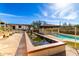 Relaxing backyard featuring a pond, beautiful plants, and a pool at 44434 N 20Th St, New River, AZ 85087