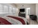 Spacious bedroom featuring built-in cabinets, a flatscreen television and a comfortable chair at 44434 N 20Th St, New River, AZ 85087
