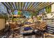 Patio fire pit area with pavers, chairs, and trellised shade at 44434 N 20Th St, New River, AZ 85087