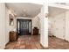 Inviting foyer featuring terracotta tile floors, a statement staircase, and a solid wood door at 44434 N 20Th St, New River, AZ 85087