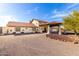 Expansive Southwestern house with a porte cochere, fountain, and neutral stucco against a bright sky at 44434 N 20Th St, New River, AZ 85087
