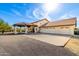 Southwestern-style home features a porte cochere, fountain, and ample parking on a sunny day at 44434 N 20Th St, New River, AZ 85087