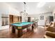 This large game room includes a pool table, stainless refrigerator and hardwood floors at 44434 N 20Th St, New River, AZ 85087