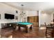 Spacious game room features a pool table and entertainment center at 44434 N 20Th St, New River, AZ 85087