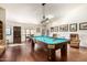 Spacious game room with a pool table, hardwood floors, and dining area at 44434 N 20Th St, New River, AZ 85087