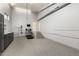 Spacious garage area with white stairs and storage at 44434 N 20Th St, New River, AZ 85087