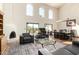 Open-concept living area with a fireplace, high ceilings, and access to outdoor living space at 44434 N 20Th St, New River, AZ 85087