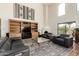 Inviting living room with high ceilings, fireplace, built-in shelving, and comfortable leather seating at 44434 N 20Th St, New River, AZ 85087