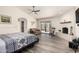 Spacious main bedroom with wood floors, vaulted ceiling, fireplace, and sliding doors with a garden view at 44434 N 20Th St, New River, AZ 85087