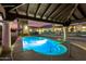 The backyard pool and spa are set under a wood-covered patio with views of the house at 44434 N 20Th St, New River, AZ 85087
